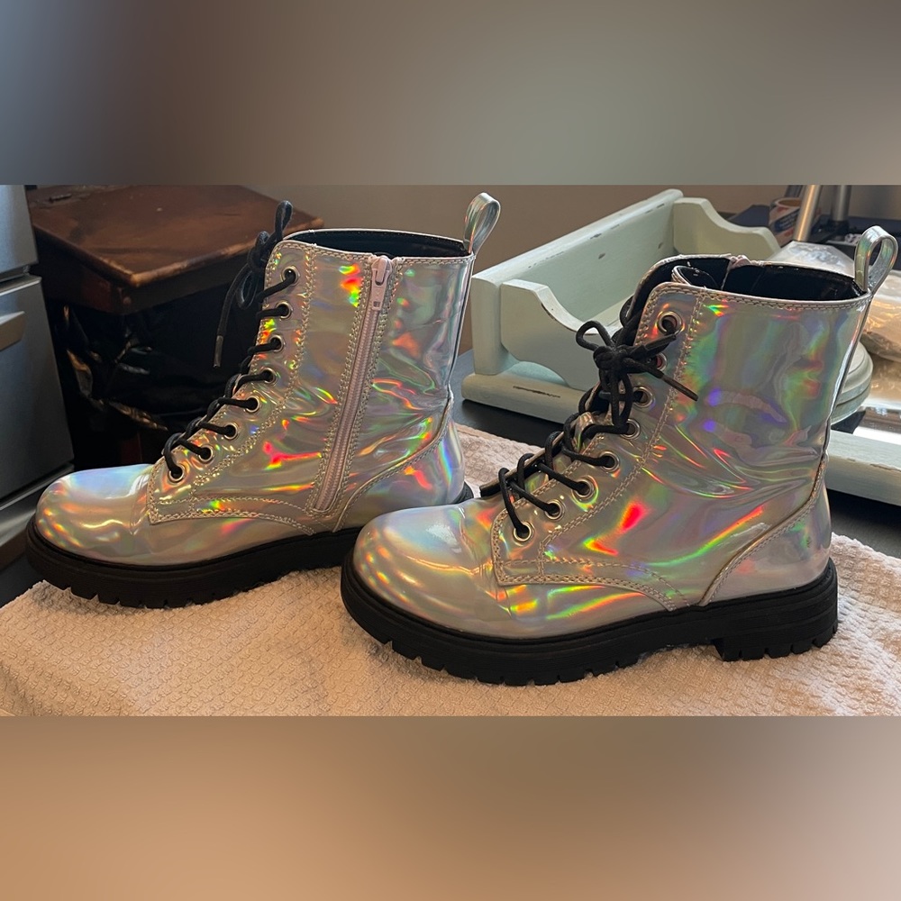 Size 7 Combat boot style. Zipper on the inside of boot. Wore a couple of times.